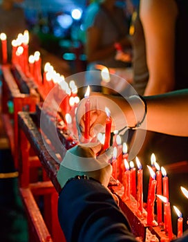 Burning red chinese candle in temple photo