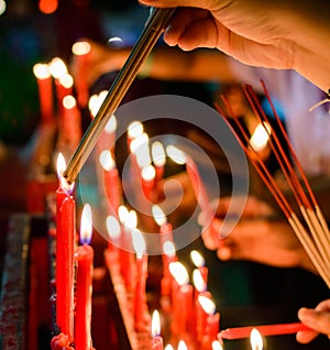 Burning red chinese candle in temple photo