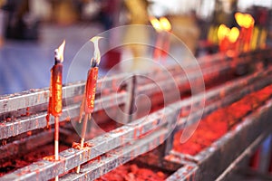 Burning red chinese candle in temple at Thailand