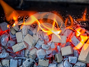 burning red coals and charcoal in barbecue grill