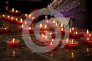 Burning red flower candle at chinese shrine for making merit in