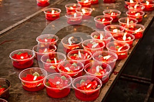 Burning red flower candle at chinese shrine for making merit in