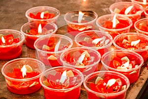 Burning red flower candle at chinese shrine for making merit in