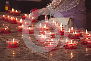 Burning red flower candle at chinese shrine for making merit in