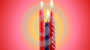 Burning and rotating three candles with burning flame