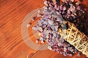 Burning sage and crystals on wooden background, amethyst