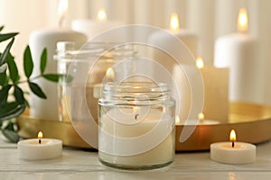 Burning scented candles for relax on white wooden table