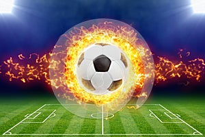 Burning soccer ball above green football stadium