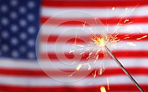 Burning sparkler against USA flag, space for text. Happy Independence Day