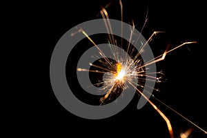 Burning sparkler on black background,