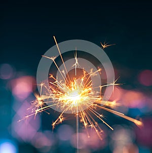 Burning sparkler with blurred background photo