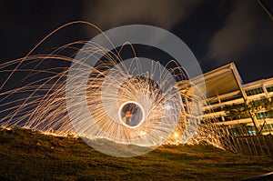 Burning steel wool sparks light trail
