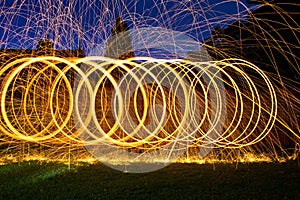 Burning steel wool spin in circles to make patterns