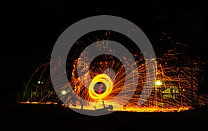 Burning steel wool spinned in the forest. Showers of glowing spa