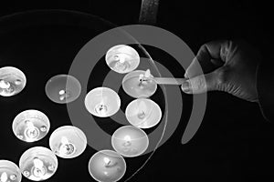 Burning tea candles on a dark background