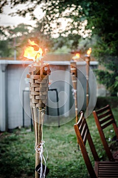 Burning tiki torch in the backyard