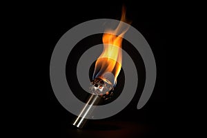 Burning torch on a black background, close-up, Fire torch on a dark background, AI Generated