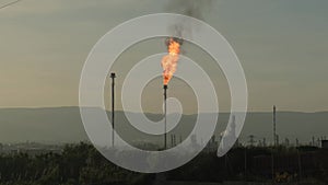 Burning a torch at a chemical plant. Emission of harmful substances into the atmosphere