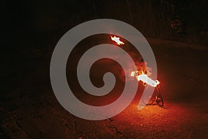 burning torch with flames, amazing fire show at night at festival or wedding party. fire show performance and entertainment. Fire