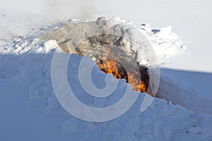 Burning trash in the snow. A place for incineration of household waste in the garden