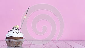 Burning up fire candle on testy sweet chocolate cup cake with white cream