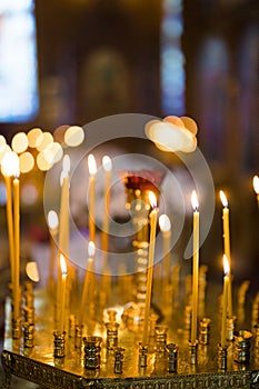 Burning wax candles in candlesticks in the Orthodox Church