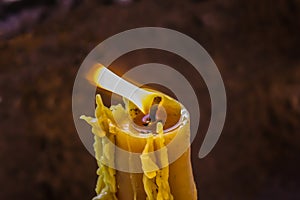 Burning wick of a beeswax candle