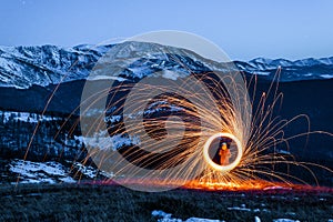 Burning Wirewool being used to make circle like light trails at Night on the Tarcu montain. Romania. Caras Severin photo