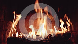 Burning wood in stone fireplace close up interior