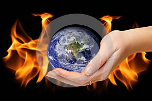 Burning world earth. Global catasrtophe concept. This image elements furnished by NASA. Apocalypse. Planet Earth in hand