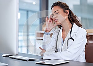 Burnout can cause physical problems. a young female doctor suffering from a headache at work.