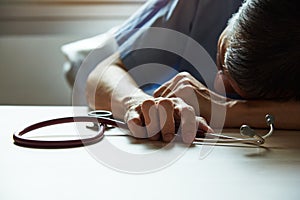 A burnout doctor feeling tired in medical office photo