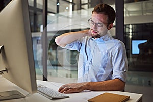 Burnout, neck pain and tired with an exhausted businessman working on a computer in his office late at night. Stress