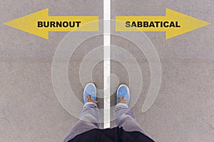 Burnout or sabbatical text on asphalt ground, feet and shoes on photo