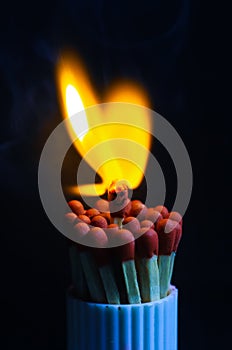 Burnout syndrome, stress, exhaustion and work-life balance concept. Close-up of a single burnt match in a group of matches. One ma