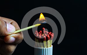 Burnout syndrome, stress, exhaustion and work-life balance concept. Close-up of a single burnt match in a group of matches.