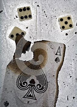 Burnt ace of spades and dices in ice