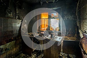 Burnt apartment house interior. Burned furniture and charred walls in black soot