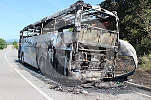 Burnt bus is seen on the road after caught in fire during travel