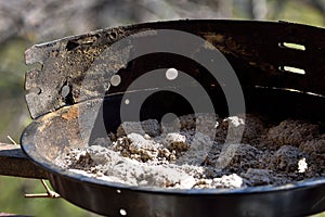 Burnt charcoal, charcoal ash in an extinct grill