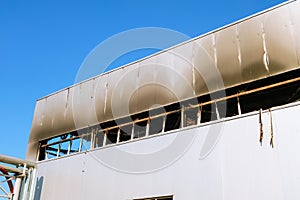 Burnt facade of an industrial workshop building after a fire