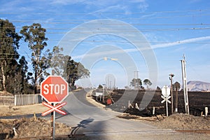 Burnt Farm Field with Railway Crossing in Foreground