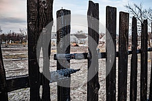 Burnt fence boards after a fire in a private house.