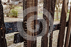 Burnt fence boards after a fire in a private house.