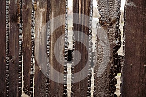 Burnt fence boards after a fire in a private house