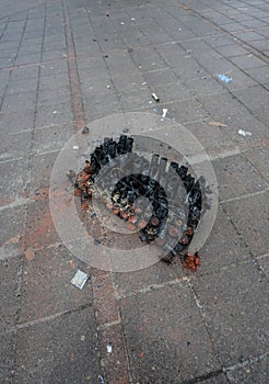 burnt firework remains on pavement..