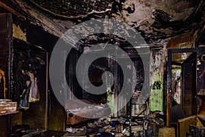 Burnt house interior. Burned furniture, charred walls and ceiling in black soot