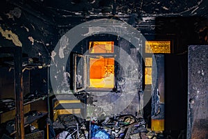 Burnt house interior. Burned furniture, charred walls and ceiling in black soot