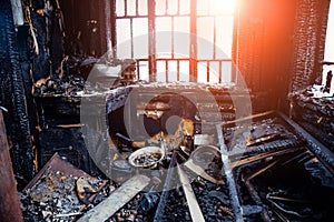 Burnt house interior. Burned kitchen, remains of furniture in black soot