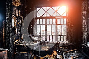 Burnt house interior. Burned kitchen, remains of furniture in black soot